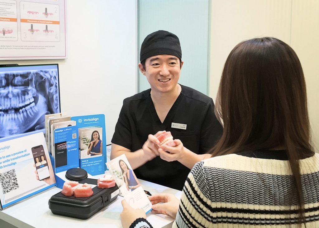 Dr. Brian Bak Junbeom discussing Korean ceramic veneers with a patient during a consultation at Meiplus Dentalcare